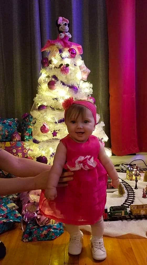 Aurély participe au concours pour gagner de l'argent avec cette photo : baby, baby_toddler_clothing, birthday, birthday_party, child, christmas_tree, costume_accessory, curtain, day_dress, dress, embellishment, interior_design, magenta, party, party_hat, party_supply, person, pink, purple, toddler