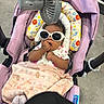 Madolyn is registered to the contest to win money with this photo: baby, stroller, sunglasses, blanket, hand, face, person, purple, fan, floor, cute, infant, child, clothing, accessory, comfort, indoor, protection, relaxation, toy