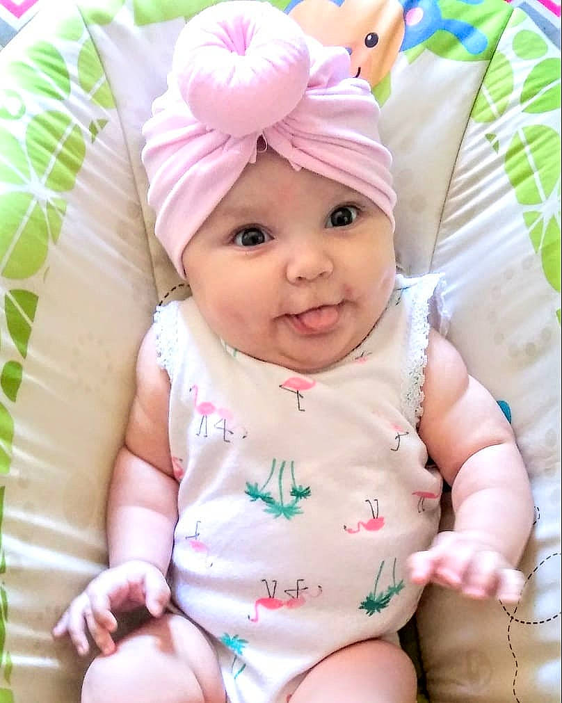 Lidia is registered to the contest to win money with this photo: baby, baby_products, baby_toddler_clothing, cheek, child, headgear, person, pink, product, skin, smile, toddler