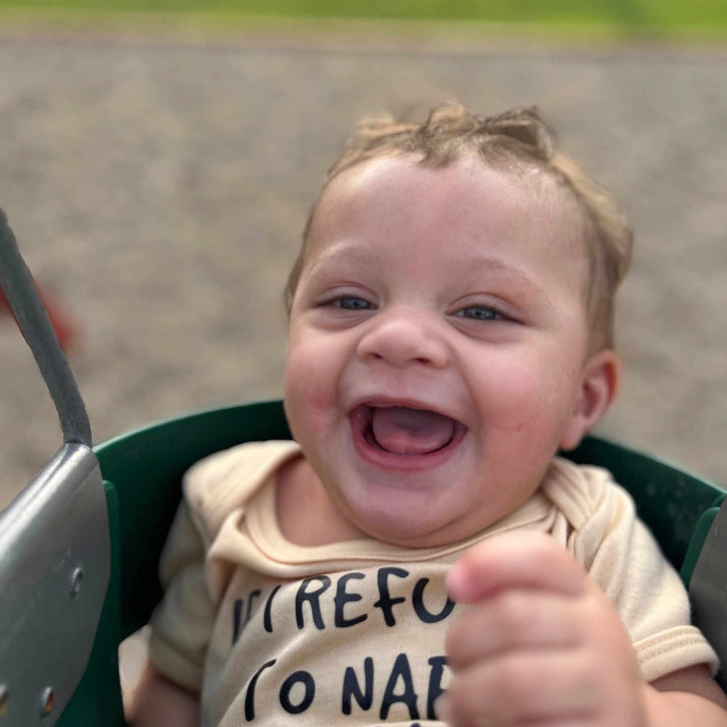 Liam is registered to the contest to win money with this photo: baby, babylaughing, bodypart, clothing, face, finger, grass, hand, happy, head, laughing, outdoorplayarea, outdoors, person, photography, plant, playarea, portrait, smile, t_shirt