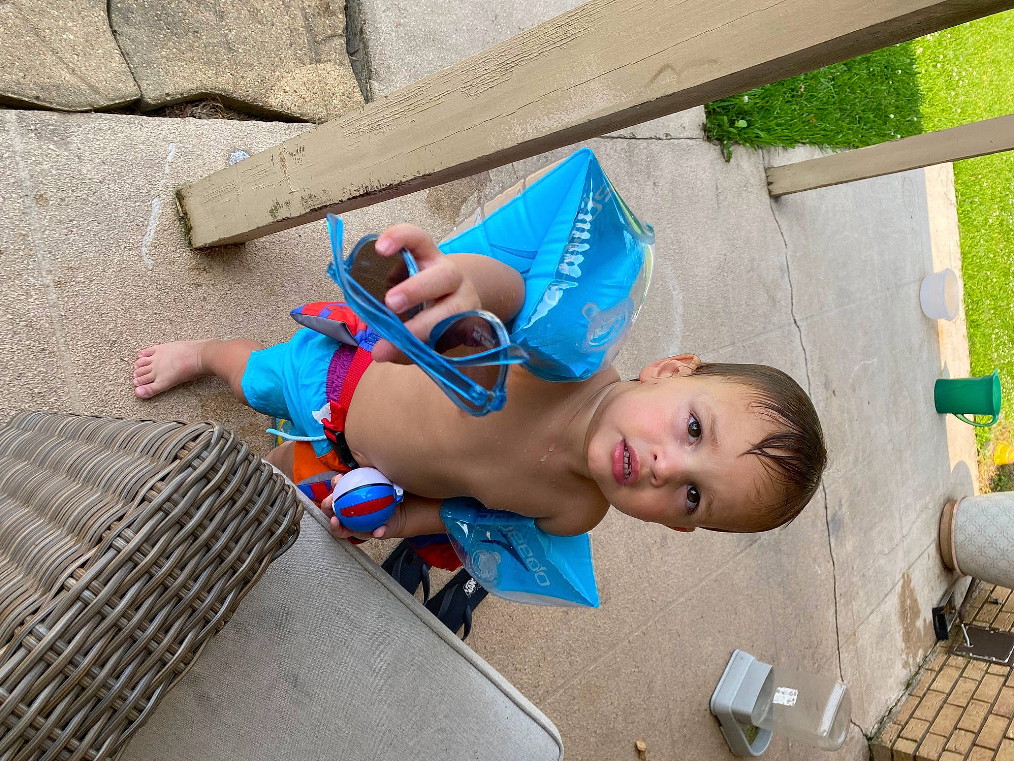 Felix is registered to the contest to win money with this photo: baby, child, electric_blue, fashion_accessory, fun, grass, happy, leisure, pattern, person, play, sitting, swimwear, toddler, vacation, wood