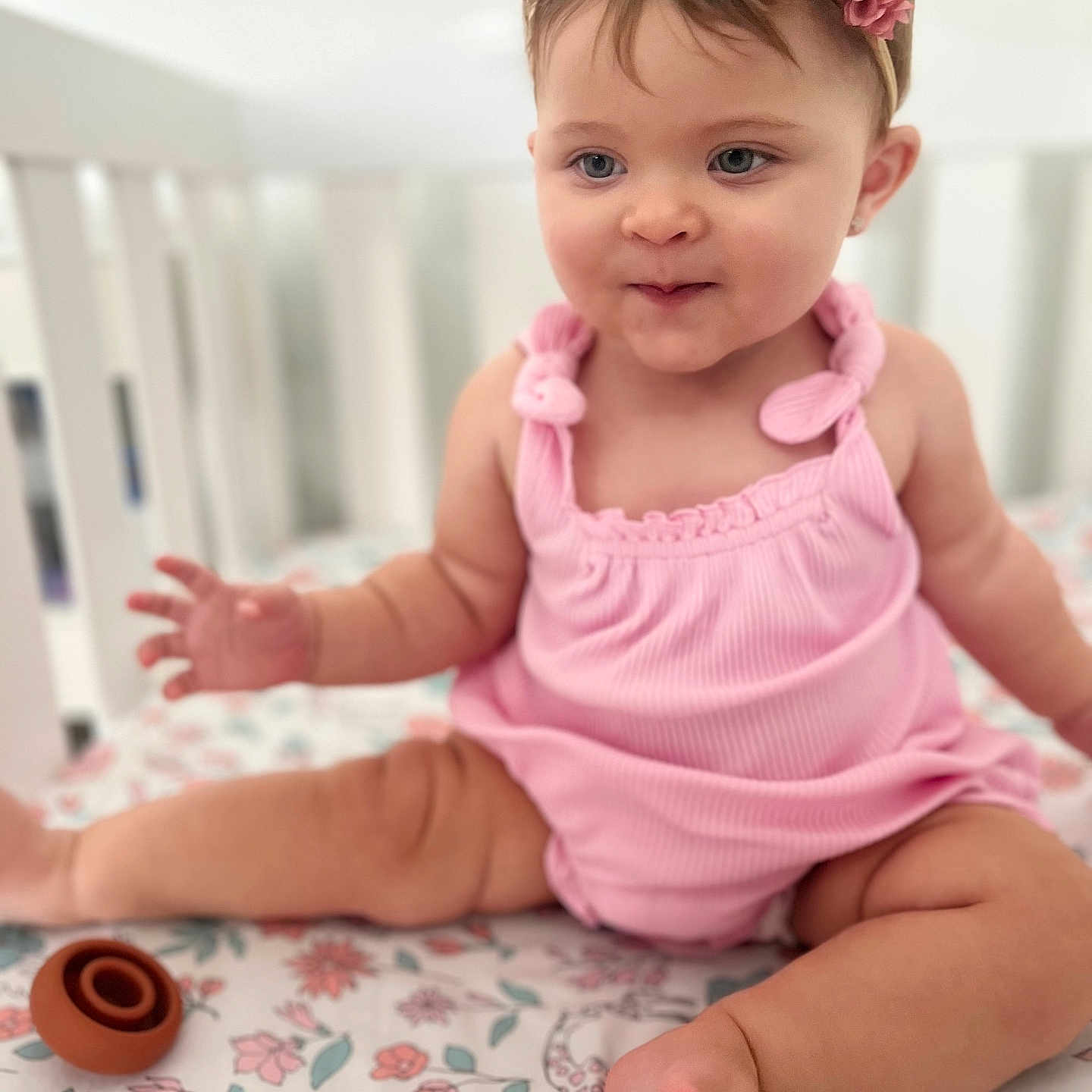 Sofia is registered to the contest to win money with this photo: accessories, baby, bed, bodypart, clothing, crib, cushion, face, finger, furniture, hand, head, homedecor, indoors, infantbed, jewelry, person, photography, portrait, sitting