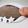 newborn, baby, sleeping, swaddled, brown_wrap, white_pillow, crescent_moon, stars, plush, soft, infant, cute, peaceful, portrait, indoors, closeup, child, resting, nursery, cozy