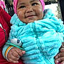 Nyimah is registered to the contest to win money with this photo: accessories, baby, bodypart, bonnet, cap, clothing, coat, face, finger, glove, hand, happy, hat, head, jacket, pants, person, photography, portrait, smile