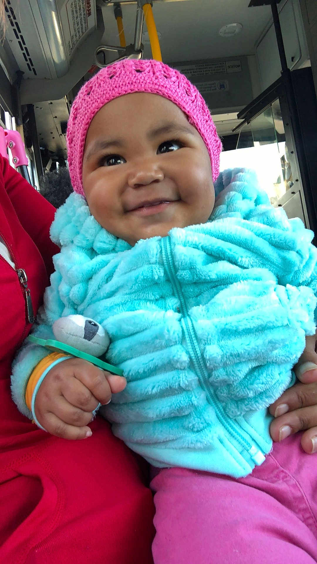 Nyimah is registered to the contest to win money with this photo: accessories, baby, bodypart, bonnet, cap, clothing, coat, face, finger, glove, hand, happy, hat, head, jacket, pants, person, photography, portrait, smile