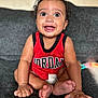 Isaiah J Anderson joined the competition — help win amazing prizes! baby, child, smiling, red_shirt, jordan, sitting, couch, indoor, hands, feet, happy, face, portrait, curly_hair, drool, infant, cute, closeup, person, casual
