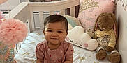 Milani joined the competition — help win amazing prizes! baby, crib, toy, plush_bunny, pillow, nursery, pink_dress, smiling, infant, child, furniture, lamp, wardrobe, clothing, indoor, play, cute, room, soft_toys, decor