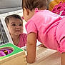 baby, child, childhood, crawling, curiosity, cute, development, early_learning, earring, face, indoor, infant, mirror, pink_clothing, play_mat, reflection, smile, toddler, toy, wooden_box