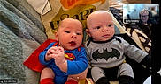 Ollie Onyx joined the competition — help win amazing prizes! babies, batman, blanket, blue_clothing, couch, faces, family, gray_clothing, indoors, infants, phone_screen, photograph, portrait, red_cape, sitting, smiling, superhero_costumes, superman, twins, video_call