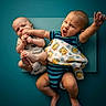 Ollie Onyx joined the competition — help win amazing prizes! babies, baby, bare_feet, blanket, children, family, indoors, infants, lying_down, open_mouth, photography, playful, portrait, raised_arm, siblings, sitting, smiling, striped_clothing, teal_background, teddy_bears