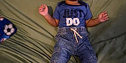 Jakai is registered to the contest to win money with this photo: bodypart, boy, child, clothing, couch, face, finger, footwear, furniture, hand, happy, head, jeans, male, pants, person, photography, portrait, shoe, sitting