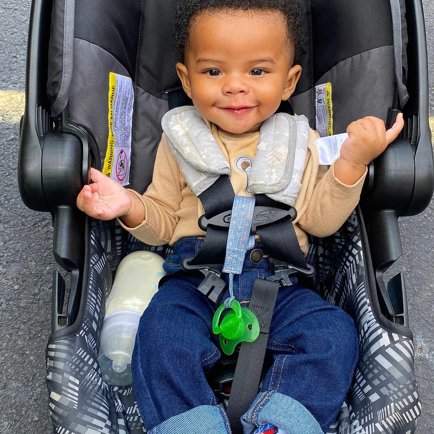 Jakyrie is registered to the contest to win money with this photo: baby, blackhair, clothing, coat, face, footwear, hair, happy, head, hosiery, jeans, pants, person, photography, portrait, shoe, sitting, smile, sneaker, sock