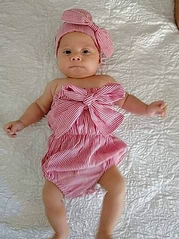 Marina a rejoint le concours — aidez-le/la à gagner de superbes lots ! baby, baby_products, baby_toddler_clothing, bonnet, child, clothing, doll, dress, headgear, headwear, pattern, person, pink, product, toddler, toy