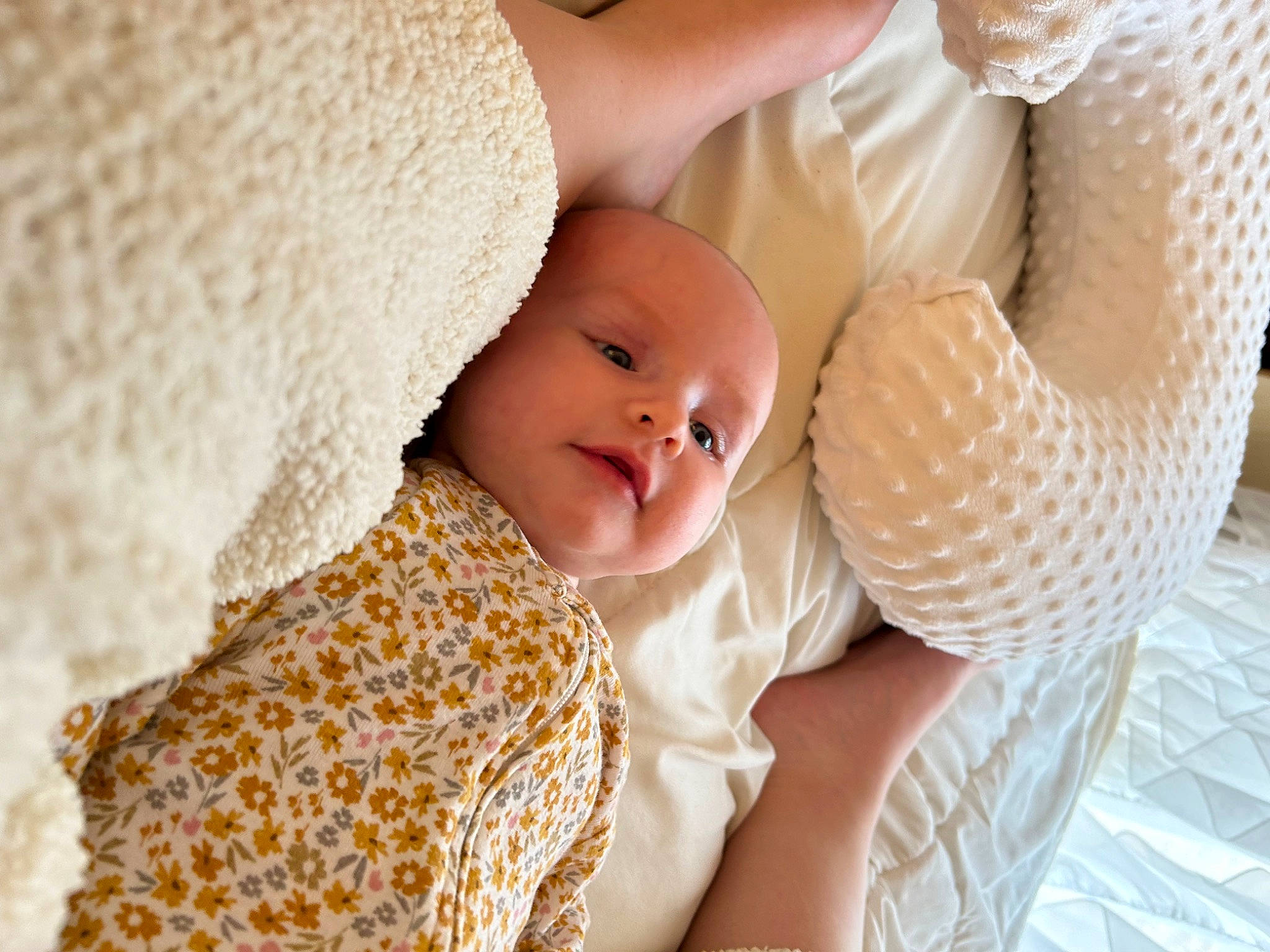 Mabel is registered to the contest to win money with this photo: abdomen, baby, baby_products, baby_sleeping, baby_toddler_clothing, bedding, cap, child, close_up, comfort, event, fashion_accessory, happy, linens, pattern, people_in_nature, person, sitting, skin, textile