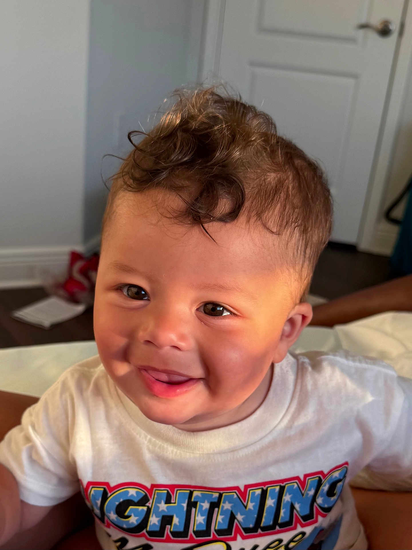 Josiah joined the competition — help win amazing prizes! child, toddler, smiling, curly_hair, indoor, tshirt, face, happy, person, portrait, cute, baby, light, expression, skin, hair, mouth, eyes, clothing, room