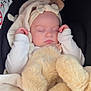 baby, sleeping, blanket, teddy_bear, headband, bow, infant, soft, cozy, cute, child, car_seat, peaceful, wrapped, plush, adorable, resting, warm, comfort, portrait