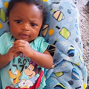 Elijah is registered to the contest to win money with this photo: baby, child, mickey_mouse, pluto, blue_blanket, patterned_blanket, toddler, hands, clothing, cartoon_characters, face, infant, cute, lying_down, indoor, person, young_child, colorful, soft_blanket, expression