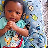 baby, child, mickey_mouse, pluto, blue_blanket, patterned_blanket, toddler, hands, clothing, cartoon_characters, face, infant, cute, lying_down, indoor, person, young_child, colorful, soft_blanket, expression