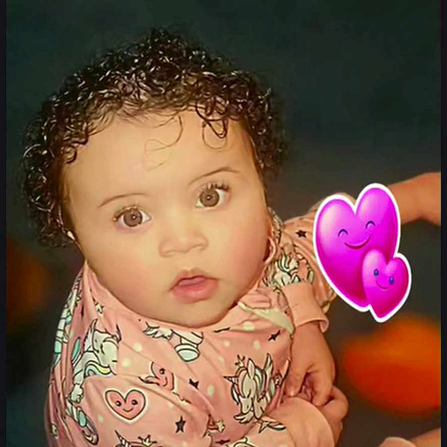 Laneisha joined the competition — help win amazing prizes! baby, child, curly_hair, cute, digital_emojis, expression, eyes, face, heart_pattern, indoor, infant, looking_up, onesie, pink_clothing, portrait, purple_hearts, sitting, skin, unicorn_pattern, young