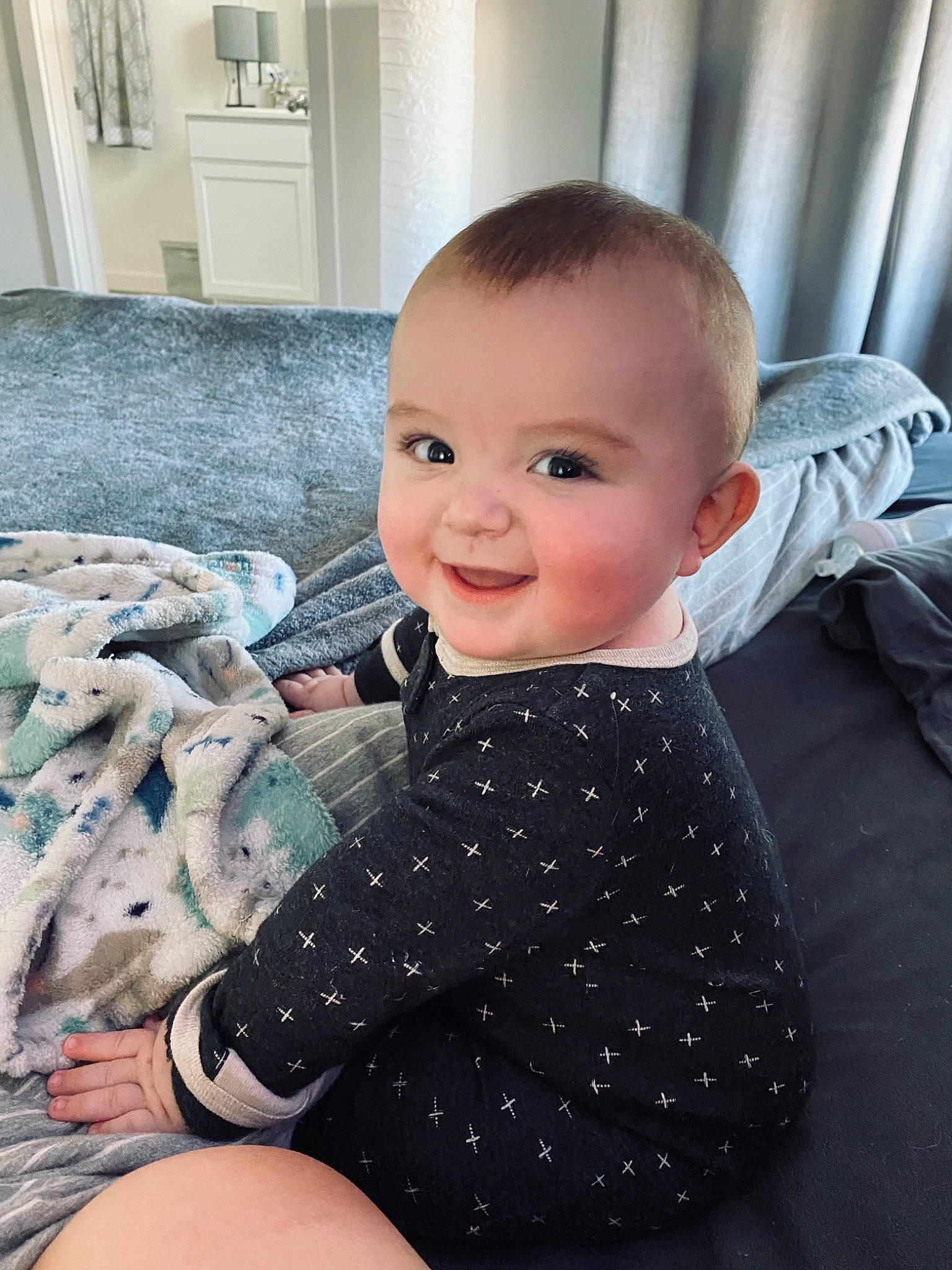 Bradley is registered to the contest to win money with this photo: baby, baby_toddler_clothing, cheek, child, chin, comfort, eye, floor, flooring, hairstyle, happy, iris, joy, mouth, nose, pattern, person, skin, sleeve, smile