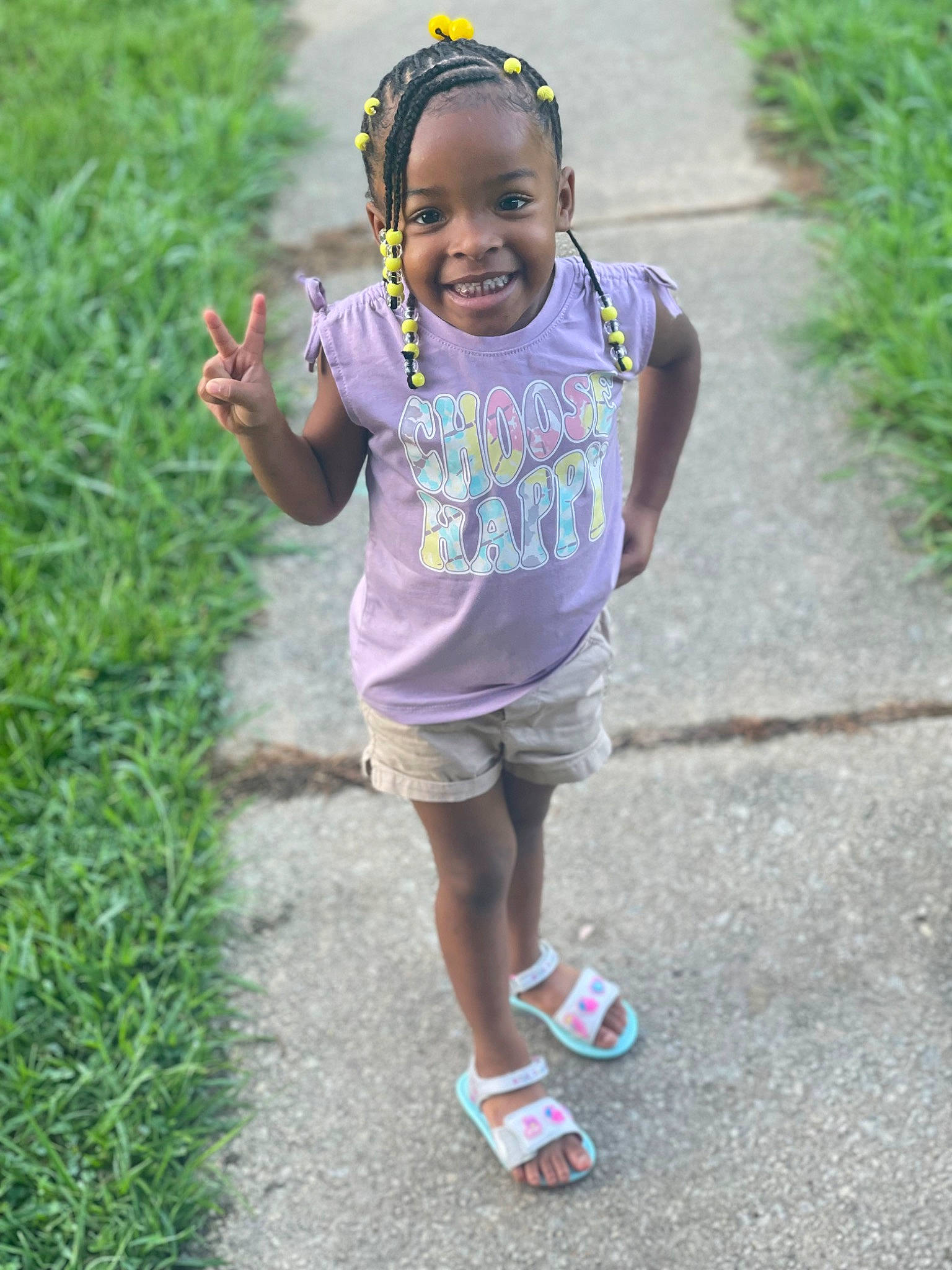 Sariyah is registered to the contest to win money with this photo: asphalt, child, eye, face, fun, grass, hair, happy, head, jewellery, joy, leisure, people_in_nature, person, plant, recreation, shorts, smile, summer, t_shirt