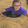 Hayzlee joined the competition — help win amazing prizes! child, glasses, purple_shirt, soybeans, seeds, outdoor, happy, smiling, sitting, barefoot, nature, playful, person, casual_clothing, young, crop, agriculture, fun, relaxed, eyewear