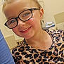 child, girl, smiling, glasses, leopard_print, shirt, indoor, portrait, happy, face, hair, casual, person, young, closeup, fashion, eyewear, cheerful, skin, human