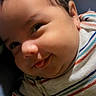 Jaziel joined the competition — help win amazing prizes! baby, child, face, smile, tongue, striped_clothing, cheeky, cute, indoor, portrait, infant, skin, hair, head, cushion, blue_background, happy, closeup, person, young