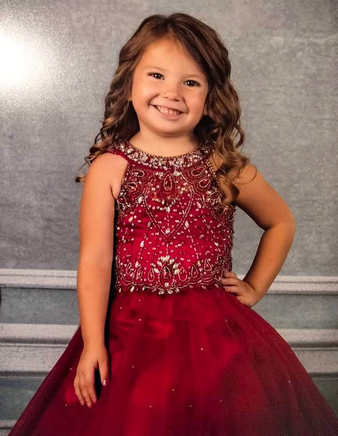 Josie is registered to the contest to win money with this photo: abdomen, beauty, day_dress, dress, face, facial_expression, fashion_design, flash_photography, formal_wear, hairstyle, happy, joy, magenta, neck, one_piece_garment, person, shoulder, smile, thigh, toddler