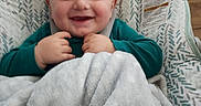 Jasper is registered to the contest to win money with this photo: baby, blanket, blue_eyes, brown_hair, child, close_up, cozy, furniture, happy, high_chair, home, indoor, infant, padded_seat, photograph, portrait, seated, smiling, teal_shirt, warning_label