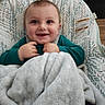Jasper is registered to the contest to win money with this photo: baby, infant, child, smiling, happy, portrait, seated, high_chair, blanket, teal_shirt, brown_hair, blue_eyes, indoor, home, furniture, padded_seat, cozy, close_up, photograph, warning_label