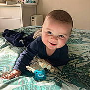 Esteban participe au concours pour gagner de l'argent avec cette photo : baby, infant, smiling, pacifier, toy_giraffe, toy, bed, blanket, leaf_pattern, nursery, dresser, basket, book, sunlight, portrait, happy, face, clothing, lying, playtime