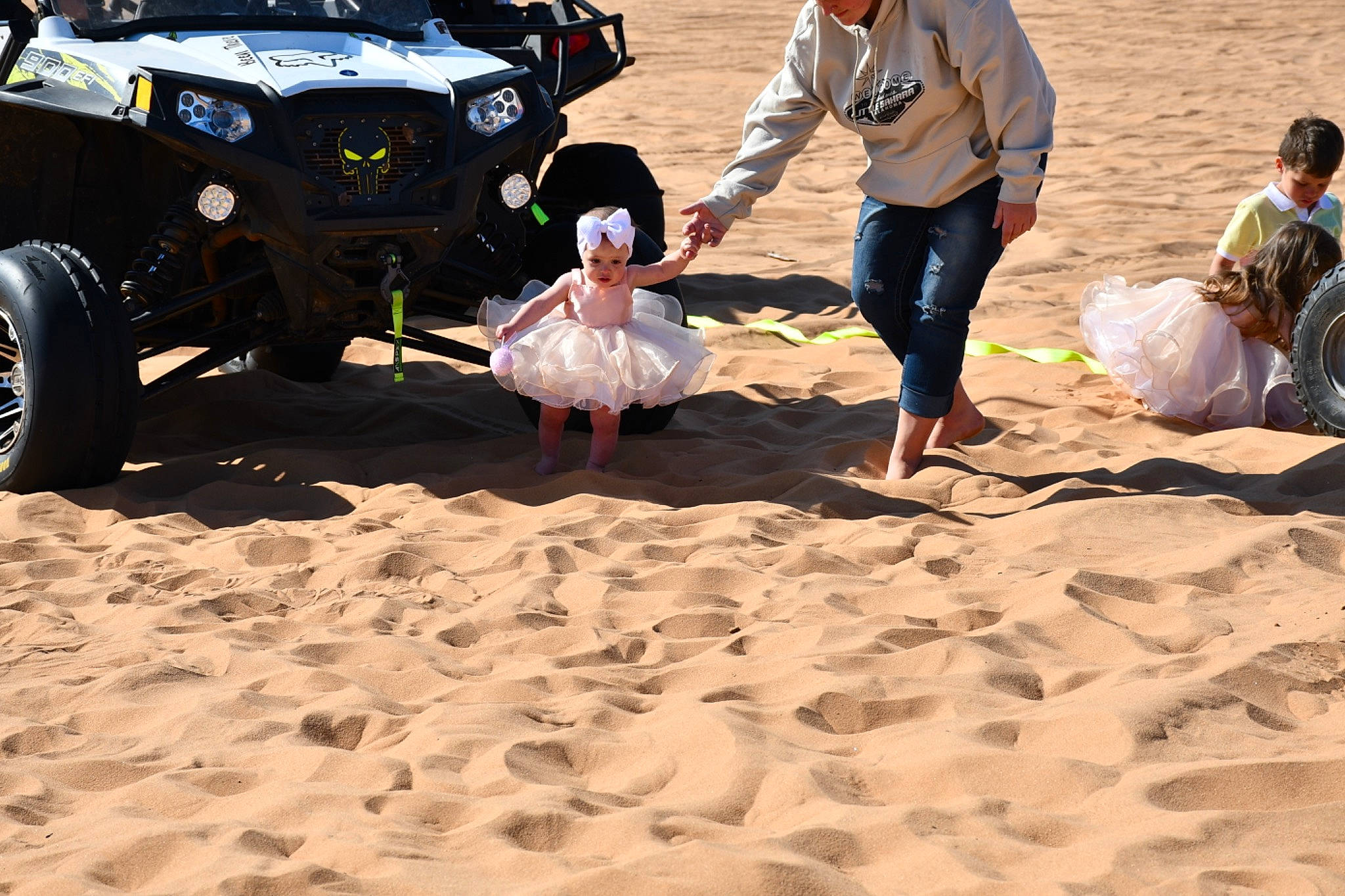 Braylea is registered to the contest to win money with this photo: automotive_design, automotive_exterior, automotive_tire, automotive_wheel_system, barefoot, beach, bumper, car, event, fun, headwear, landscape, leisure, motor_vehicle, people_on_beach, person, recreation, sand, t_shirt, tire