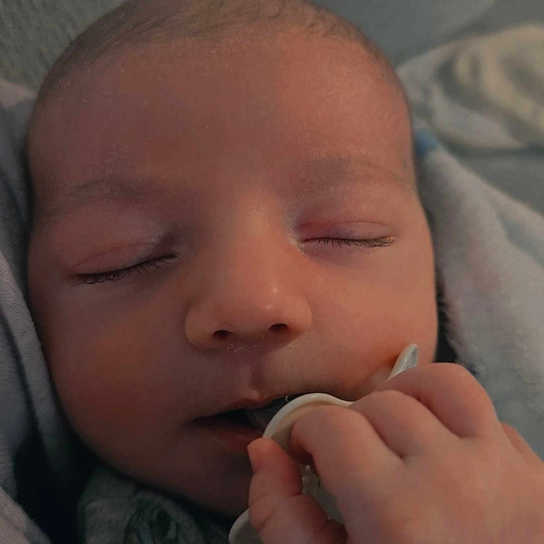 Greyson is registered to the contest to win money with this photo: accessories, baby, blade, bodypart, clothing, face, finger, hand, head, jewelry, medication, newborn, person, photography, pill, portrait, razor, ring, sleeping, weapon