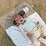Raphaël a rejoint le concours — aidez-le/la à gagner de superbes lots ! baby, beach, blanket, cap, child, clothing, cute, face, footwear_free, happy, headwear, infant, outdoor, patterned_blanket, person, relaxed, sand, smiling, sunny, young