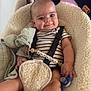 Raphaël participe au concours pour gagner de l'argent avec cette photo : baby, baby_seat, blanket, child, closeup, comfort, cute, face, furniture, head, home_interior, indoor, infant, pacifier, person, relaxed, safety_harness, smiling, striped_clothing, toy