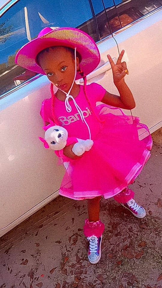 Journey is registered to the contest to win money with this photo: child, costume_hat, doll, fashion_accessory, fedora, fun, fur, happy, hat, headgear, magenta, peach, person, pink, purple, recreation, sun_hat, teddy_bear, toy, vehicle_door