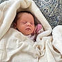 Wrenley is registered to the contest to win money with this photo: newborn, baby, sleeping, blanket, soft, cozy, infant, wrapped, peaceful, resting, cute, patterned_background, quilt, white_blanket, pink_clothing, indoors, portrait, face, hand, toddler