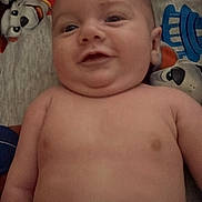 Richard Allen is registered to the contest to win money with this photo: baby, smile, infant, diaper, bare_chest, lying_down, cute, child, cartoon_blanket, face, skin, happy, indoors, playful, young, person, head, expression, comfort, resting