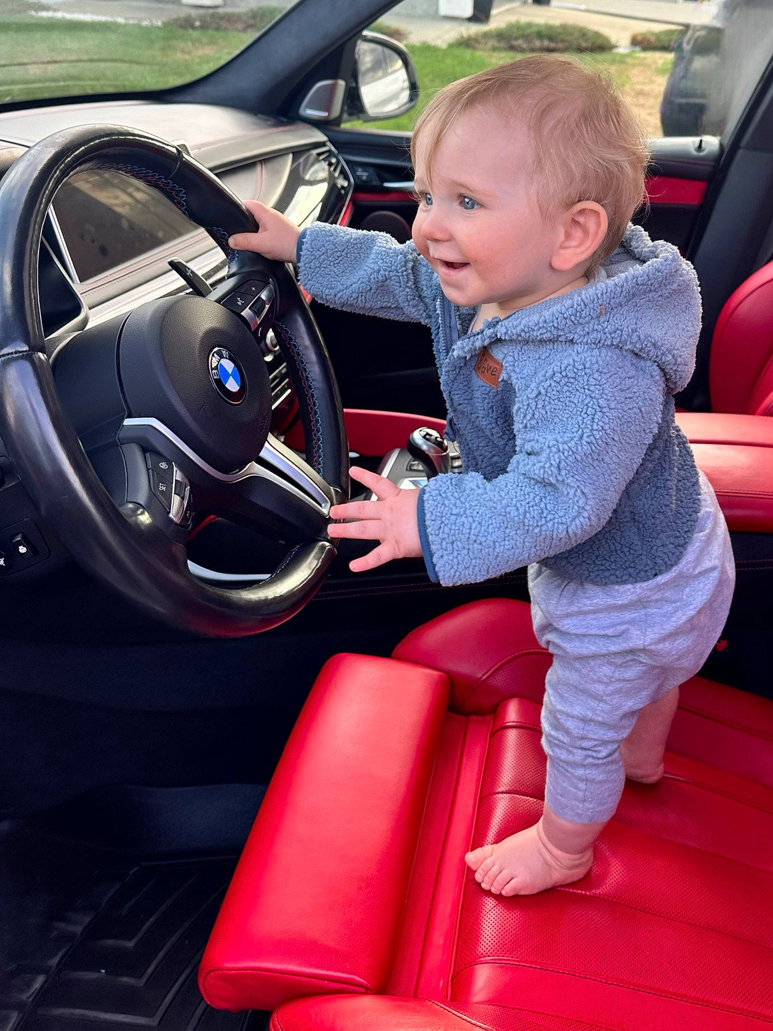Braxtyn is registered to the contest to win money with this photo: auto_part, automotive_design, automotive_exterior, automotive_wheel_system, car, car_seat, car_seat_cover, center_console, door, family_car, motor_vehicle, person, personal_luxury_car, smile, speedometer, steering_part, steering_wheel, toddler, vehicle, vehicle_door