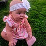 Ocean is registered to the contest to win money with this photo: baby, infant, child, girl, headband, flower, pink_dress, pink_sock, grass, lawn, outdoors, sitting, cute, chubby_cheeks, portrait, toddler, hand, feet, tire, floral_pattern