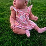 Ocean is registered to the contest to win money with this photo: baby, infant, child, pink_dress, floral_dress, headband, flower_headband, grass, lawn, outdoors, sitting, socks, chubby_legs, portrait, side_profile, hand, cheeks, vehicle_in_background, yard, summer