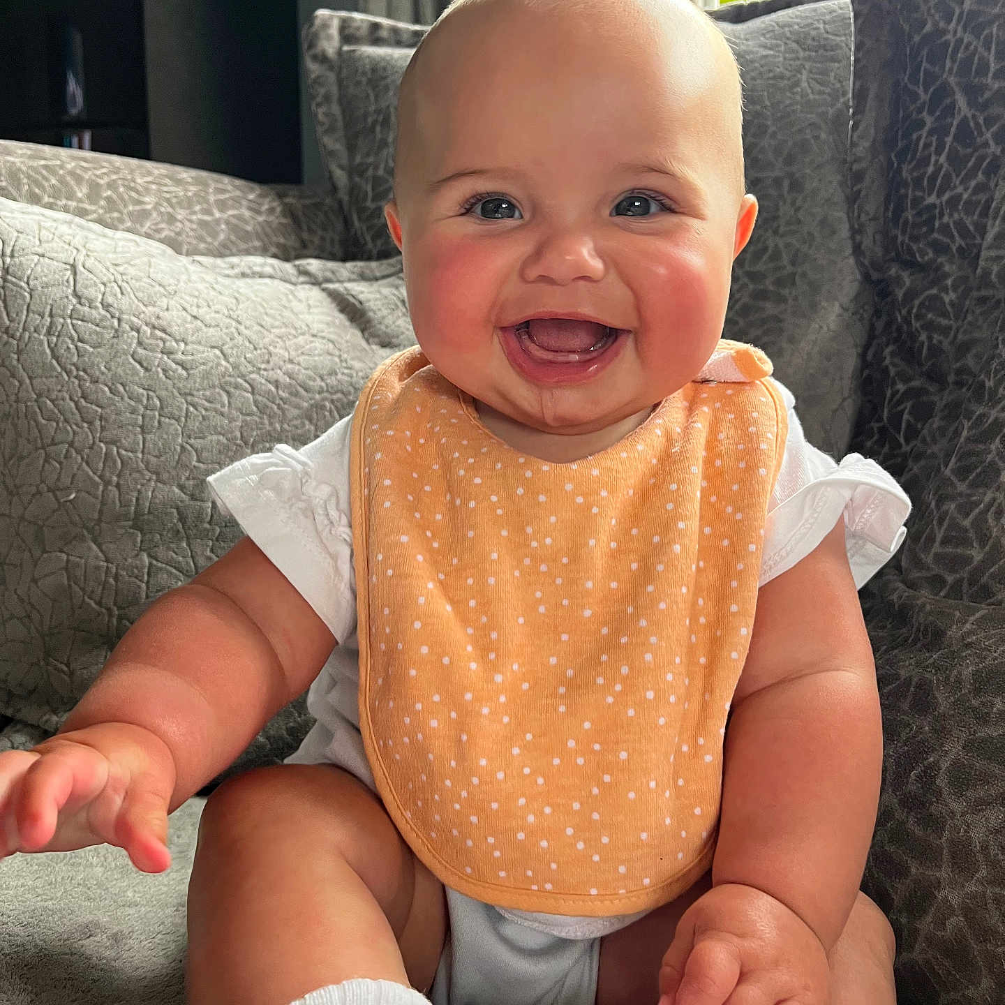 Palmer joined the competition — help win amazing prizes! baby, bib, bright_eyes, cheeks, child, couch, cushion, cute, face, happy, home, indoor, infant, person, sitting, skin, smiling, sock, soft_furniture, white_clothing