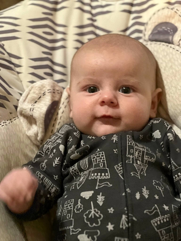 Matthew is registered to the contest to win money with this photo: baby, baby_toddler_clothing, cheek, chin, collar, eye, eyebrow, face, facial_expression, gesture, hairstyle, head, iris, lip, nose, outerwear, person, skin, sleeve, smile