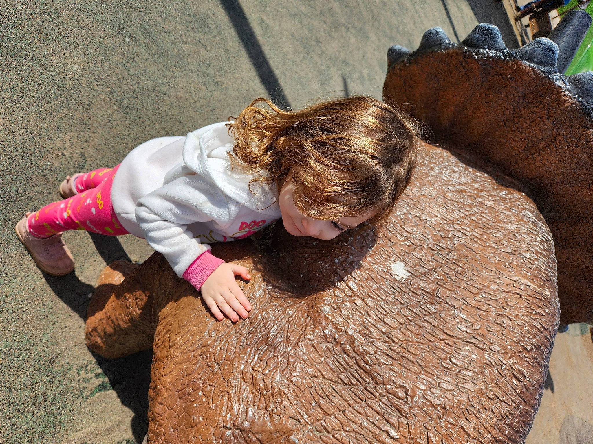 Addelyn is registered to the contest to win money with this photo: asphalt, child, concrete, flooring, fun, grass, joy, landscape, leisure, mammal, person, plant, recreation, road_surface, sand, sidewalk, sitting, soil, toddler, tree