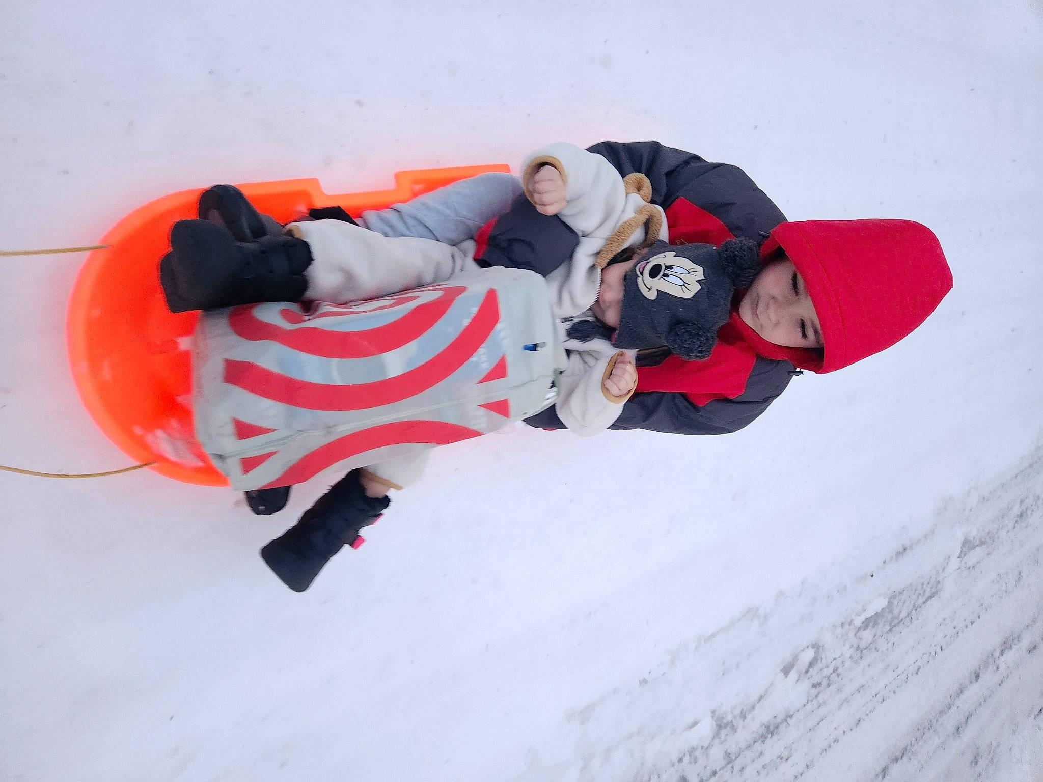 Aiden is registered to the contest to win money with this photo: adventure, boot, carmine, extreme_sport, footwear, freezing, fun, glove, headwear, ice_cap, outdoor_shoe, person, personal_protective_equipment, playing_in_the_snow, recreation, slope, snow, sports, sportswear, winter