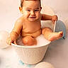 baby, balloons, bath_time, bathtub, bathwater, bucket, chubby_cheeks, cute, hands, infant, milk_bath, playful, portrait, sitting, smile, studio_background, toddler, toes, wet_skin, white_background