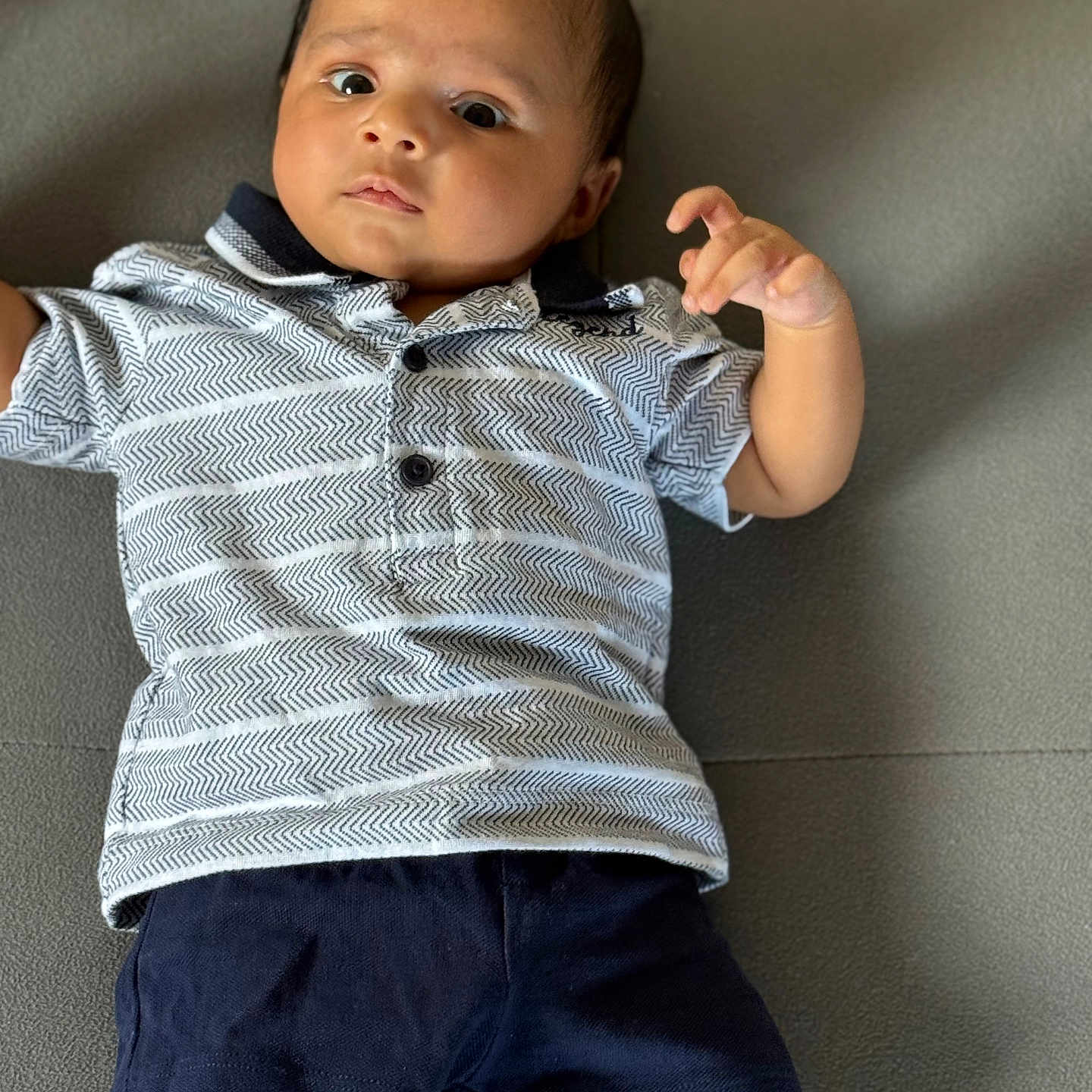 Gurfateh Singh joined the competition — help win amazing prizes! baby, casual, child, couch, expression, face, gray, hands, head, indoor, infant, legs, patterned_clothing, person, polo_shirt, portrait, shorts, sitting, skin, young