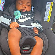 Khrome joined the competition — help win amazing prizes! baby, infant, sleeping, car_seat, pacifier, nike, black_clothing, sandals, child, portrait, vehicle, safety_harness, seated, closed_eyes, curly_hair, hands, legs, indoor, photography, calm