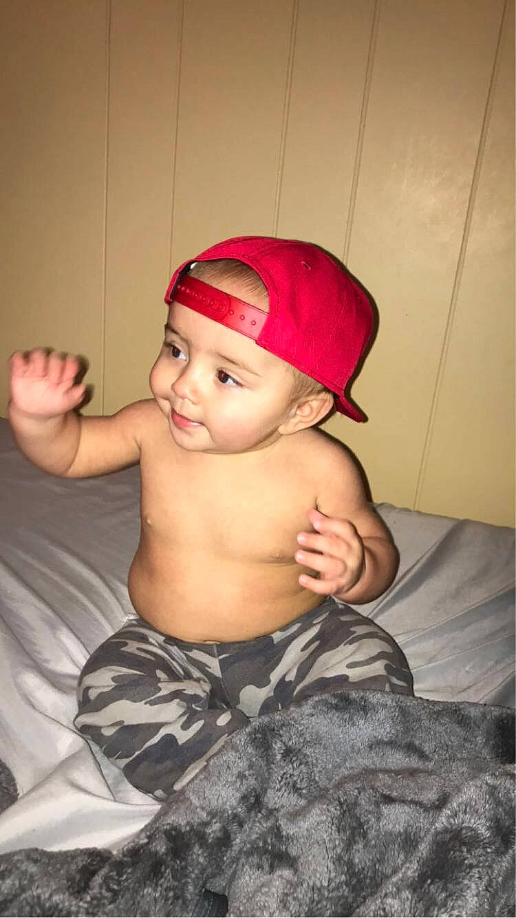 Jaxton is registered to the contest to win money with this photo: baby, baby_toddler_clothing, barechested, cap, chest, chin, elbow, eye, eyebrow, flash_photography, fun, headgear, headwear, human_body, human_leg, knee, lip, person, personal_protective_equipment, thigh